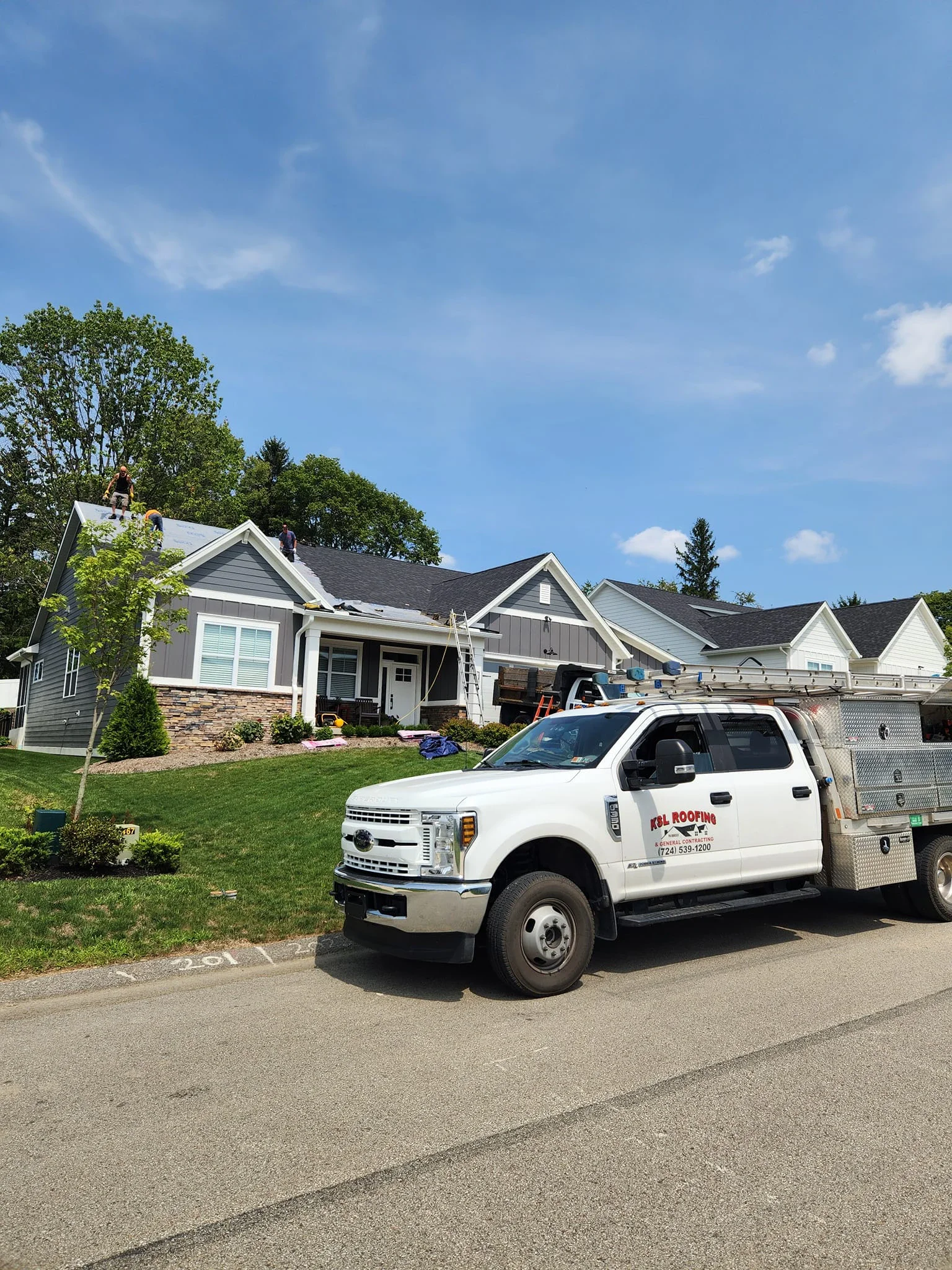 KSL Roofing Van Parked in Front of a Home